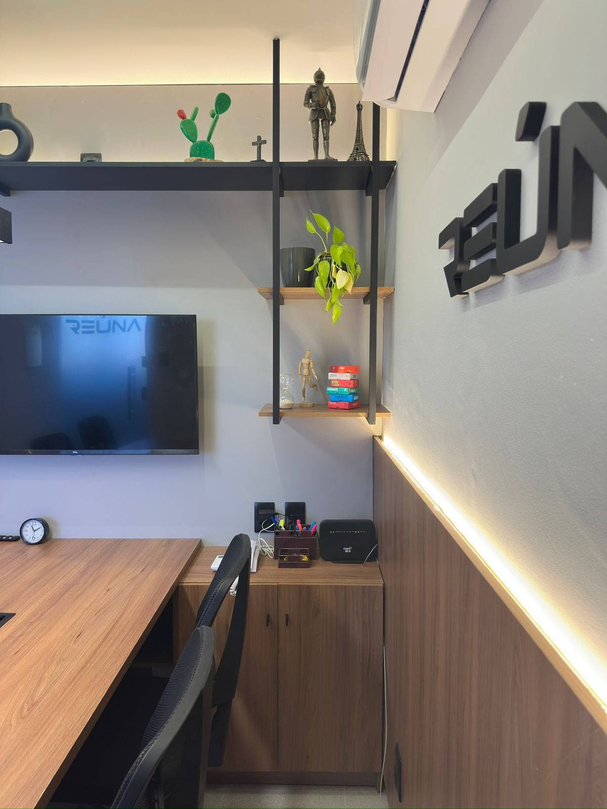 Detalhes de decoração na estante, com TV ao fundo